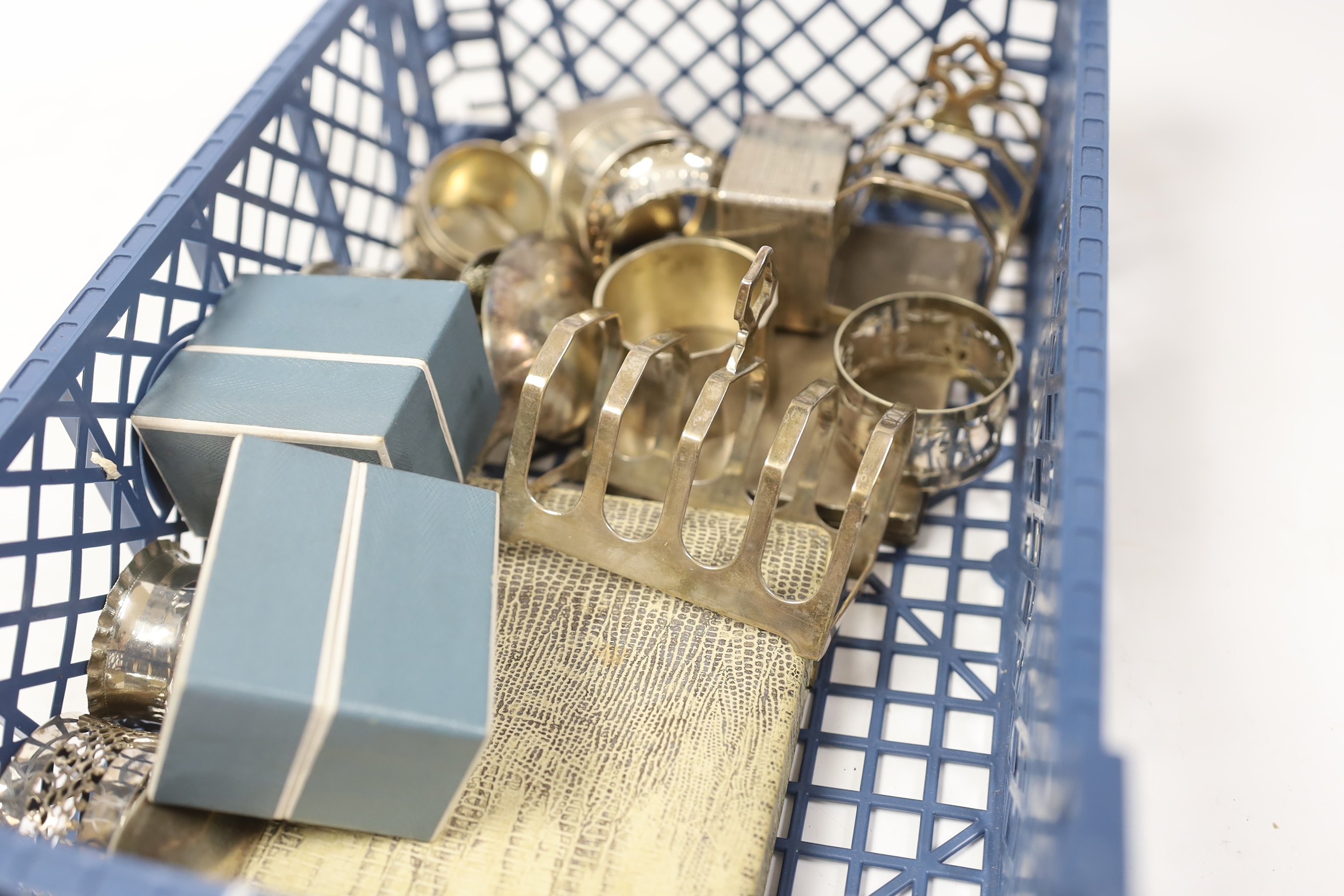 Sundry small silver including a cigarette case, cased set of six sterling and enamel cocktail sticks, two silver toast racks, a silver table spoon and eight silver napkin rings, together with six silver plated napkin rin